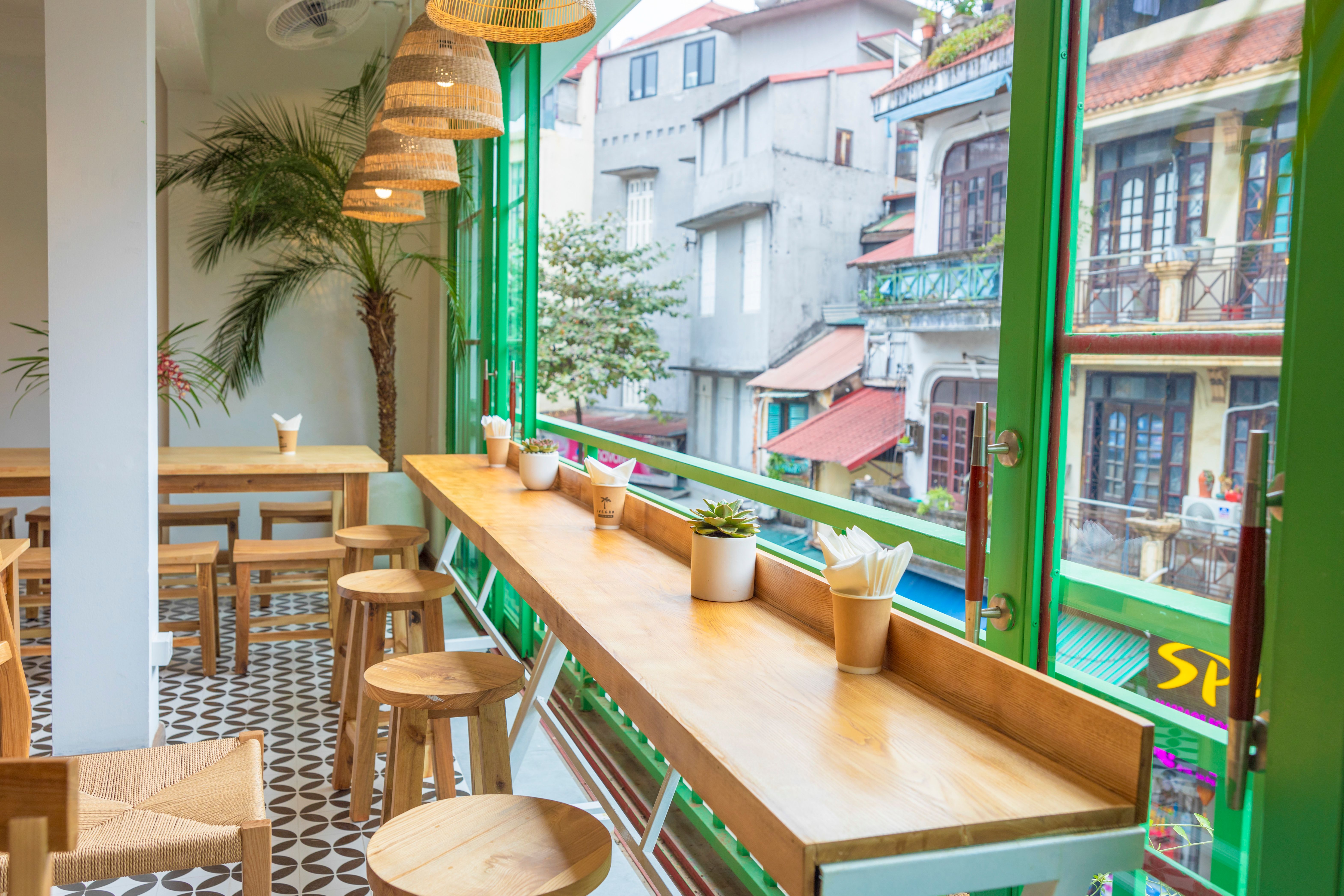 Counter and communal tables at a bright modern cafe on West Lane Avenue