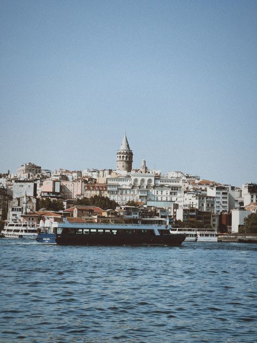 Free A picturesque scene capturing the historic Galata Tower across the Bosphorus Strait in Istanbul, Turkey. Stock Photo