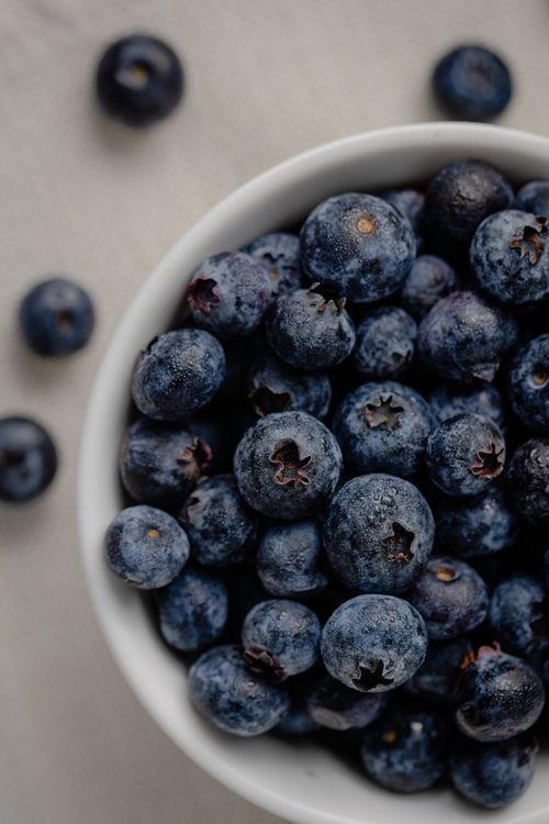 Free Close-up shot of fresh blueberries in a bowl, showcasing juicy and vibrant summer fruit. Stock Photo
