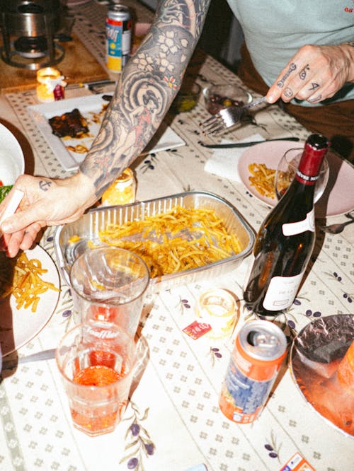 Man Hands with Tattoos over Table with Drink and Beverage