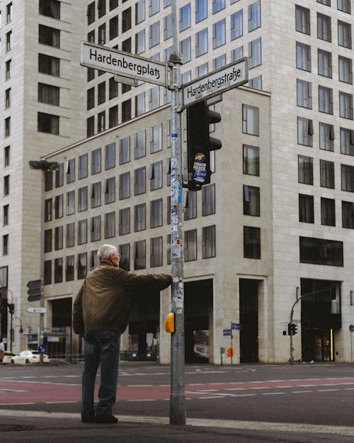 Pedestrian Waiting at Crosswalk in Downtown