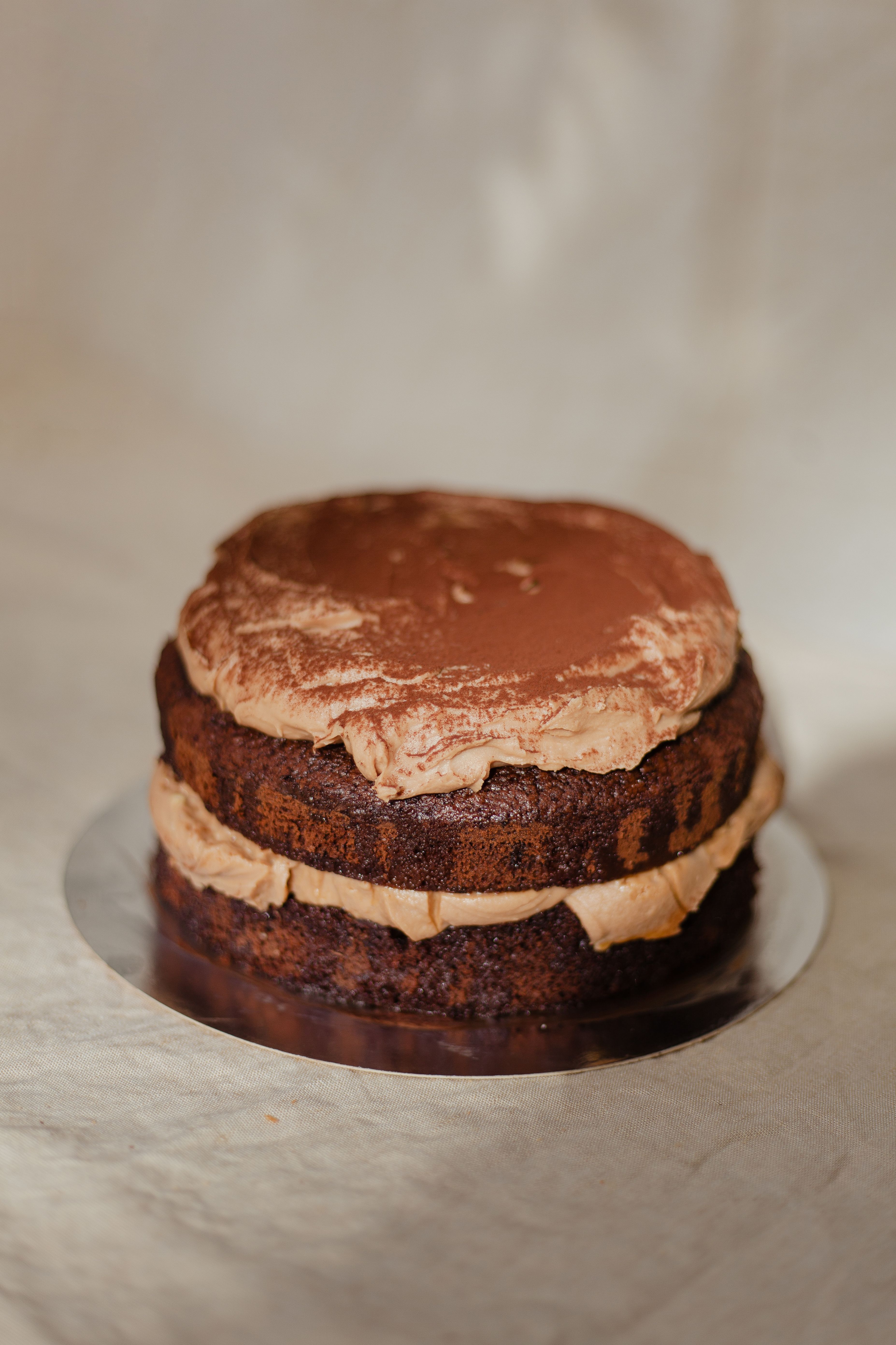 Rich and indulgent chocolate cake layered with creamy frosting, perfect for dessert enthusiasts.