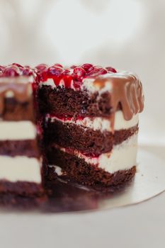 Indulge in a rich chocolate layer cake topped with berries and cream. Perfect for dessert lovers.