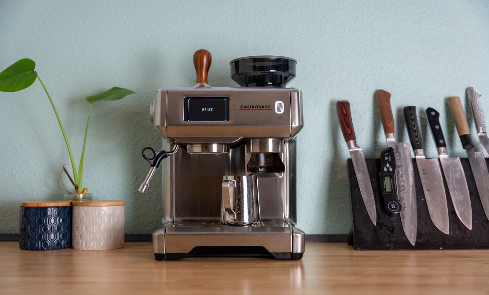 Retro-style coffee machine on a kitchen counter with mugs