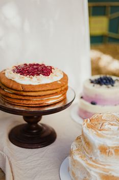 Three decadent gourmet cakes on display, perfect for dessert indulgence.