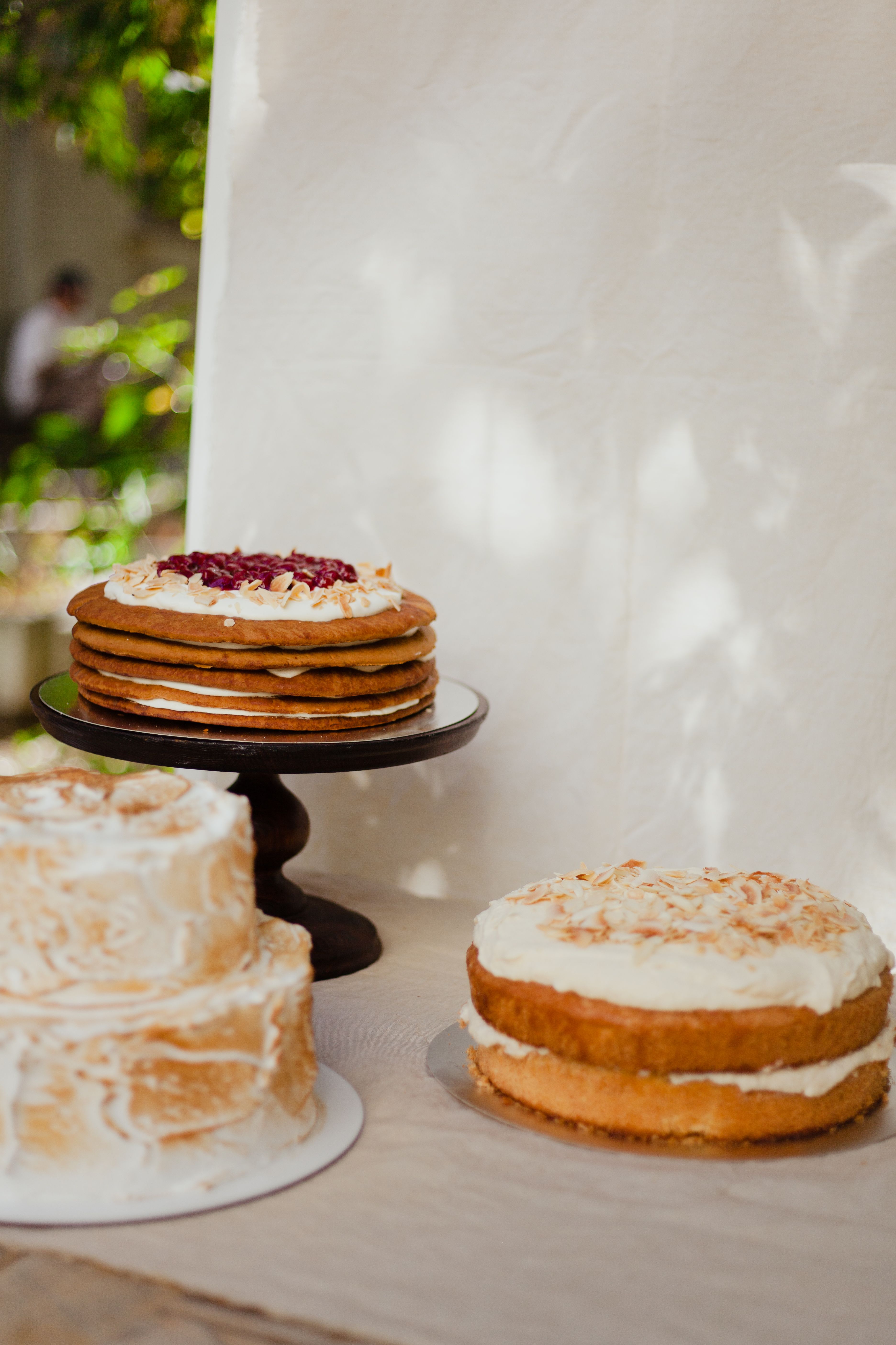 A tempting selection of cakes beautifully displayed, showcasing layers and different toppings, ideal for food enthusiasts.