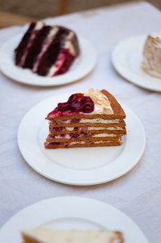 Slice of layered cake with berries and almonds, perfect dessert display for gourmet cuisine.