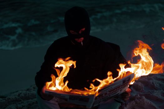 Masked Man Reading Burning Newspaper