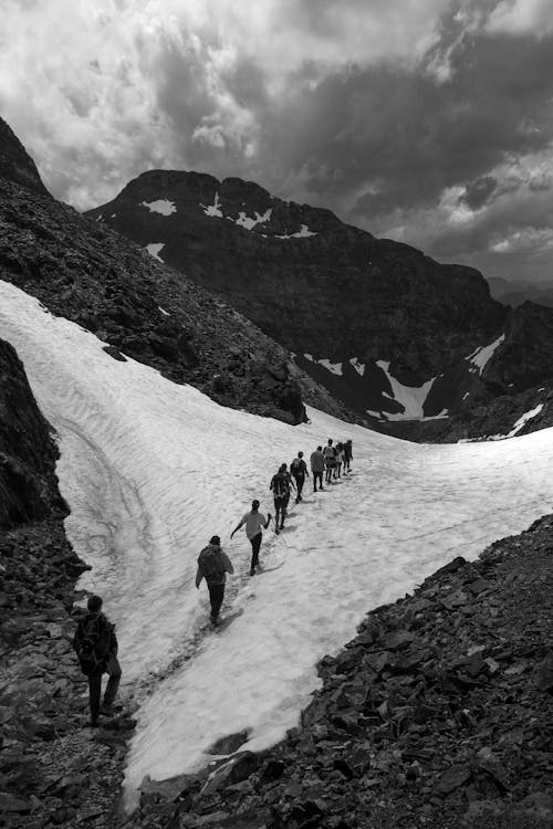 People Hiking in Mountains in Black and White