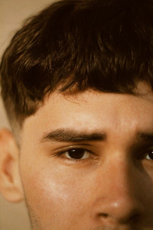 Free Focused close-up of a young man's facial features, showcasing natural expression. Stock Photo