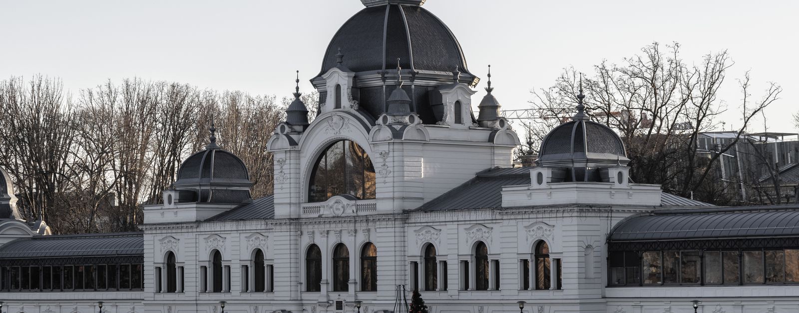 Elegant historic architecture of Budapest's City Park Ice Rink at dusk.