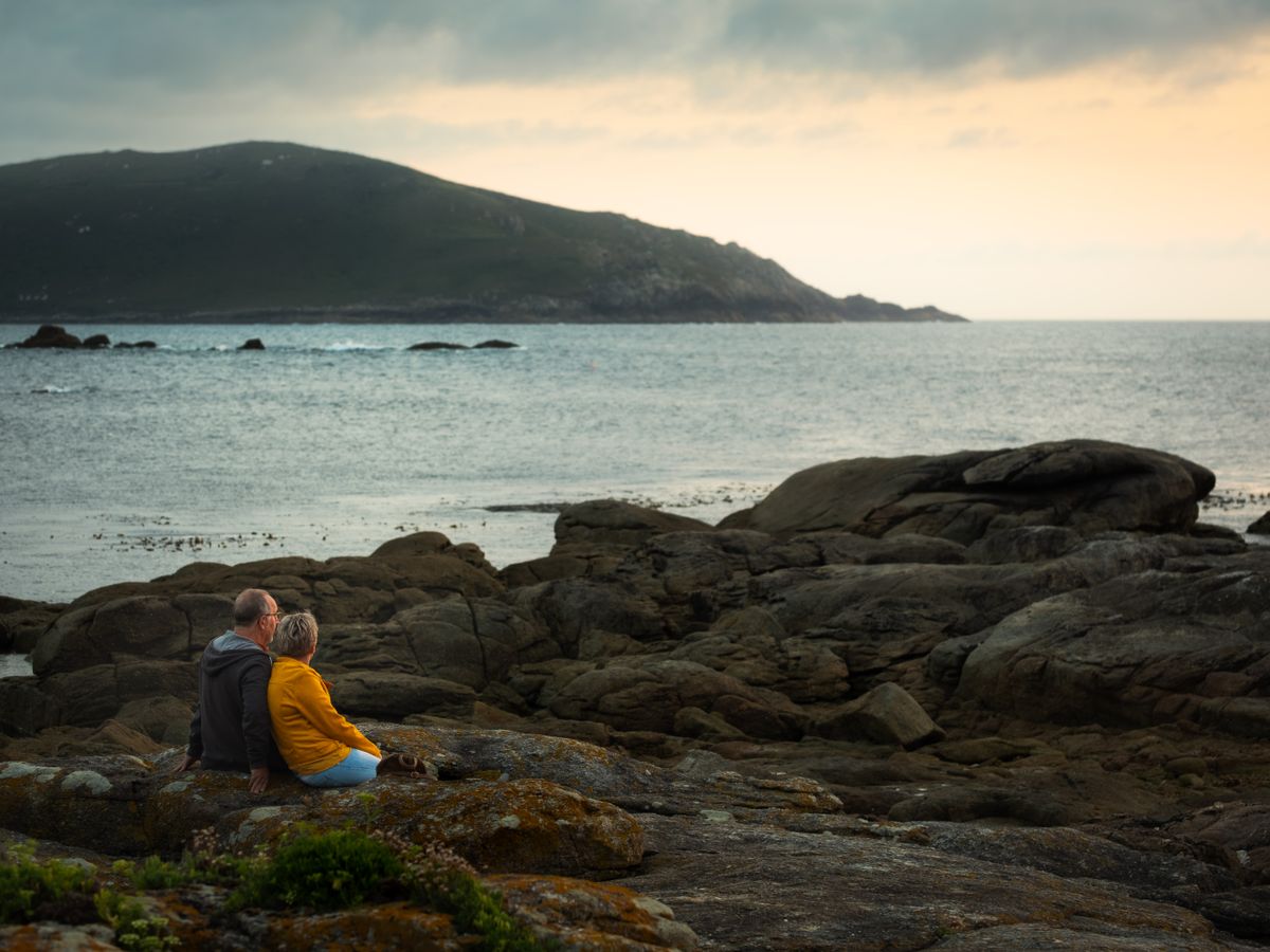 Couple relaxing together beside the Mediterranean