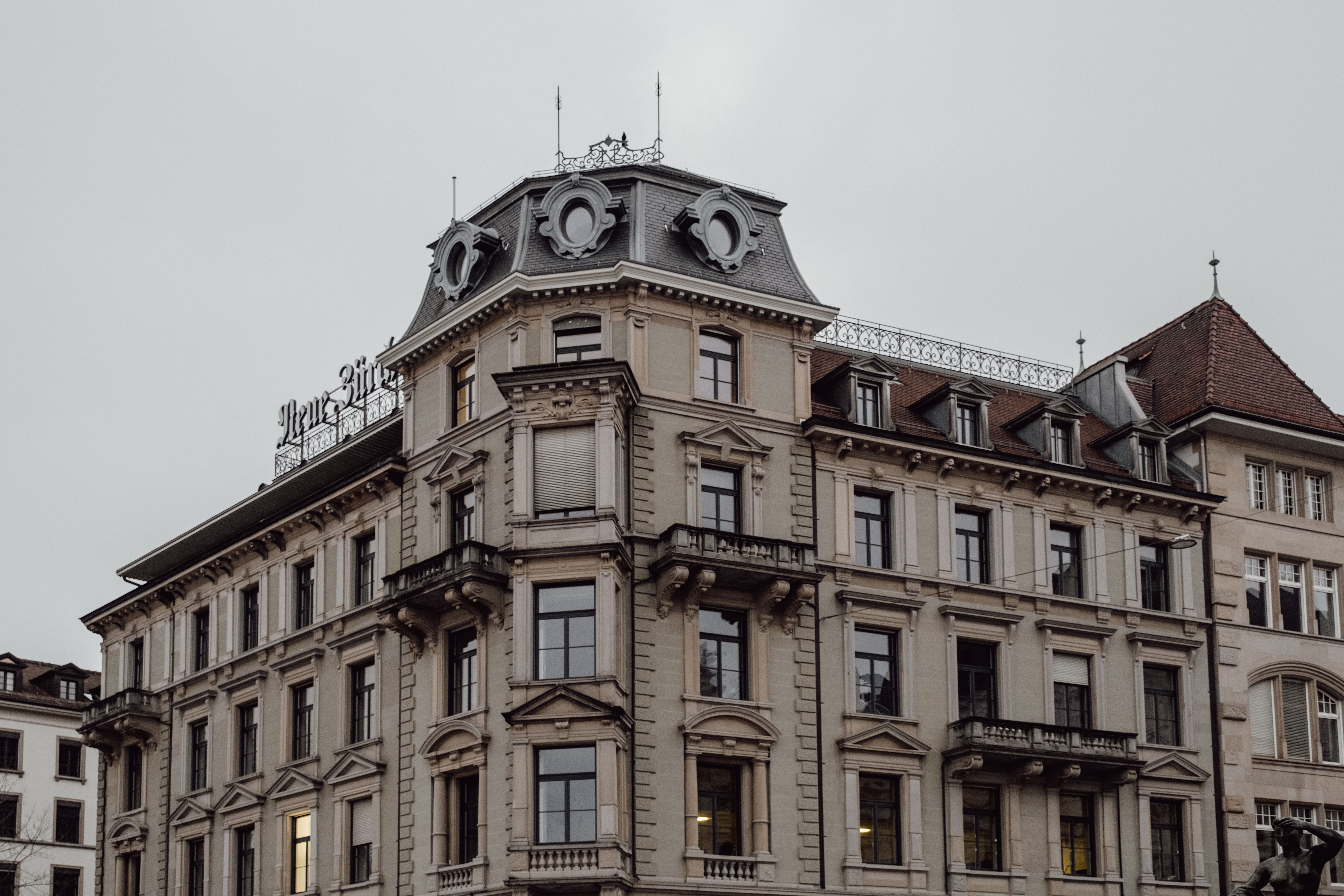 A neoclassical building in Zurich under a cloudy sky.