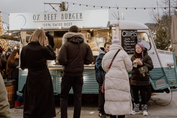 People By The Food Truck On A Street 