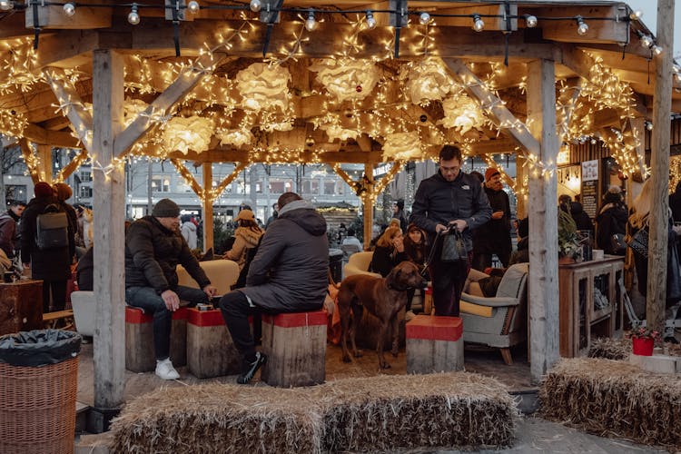 People Sitting At A Christmas Market