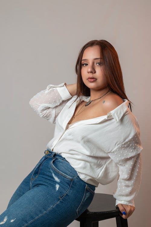 Woman in Blue Jeans and White Shirt Posing