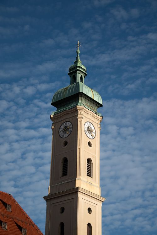 Free Gothic bell tower of historic church in Munich, Germany, under a bright blue sky. Stock Photo