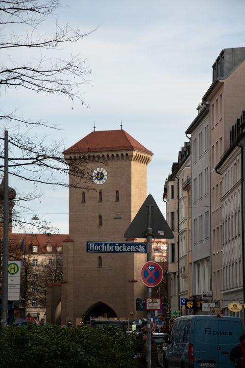 Free Street view of Isartor, a historical gate tower in Munich, Bavaria, Germany, surrounded by urban architecture. Stock Photo