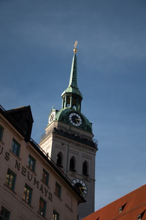 Free Vertical shot of St. Peter's Tower in Munich, Germany against a clear blue sky, showcasing Renaissance architecture. Stock Photo