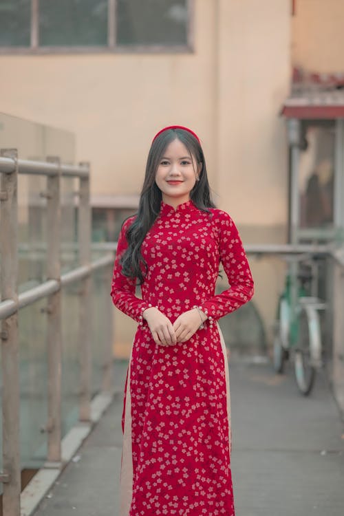 Model in a Floral Red Ao Dai Tunic and a Headband on a Pedestrian Overpass