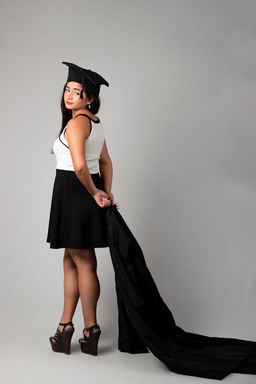 Free Student in a Mortarboard Dragging Her Graduate Gown Stock Photo