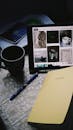 Dark Photograph of a Desk with a Mug, Notebook and a Tablet