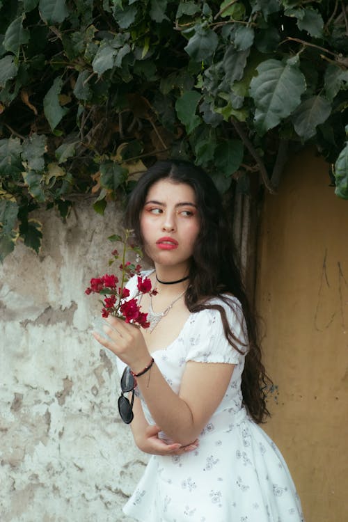 Woman in a White Dress Holding Flowers 