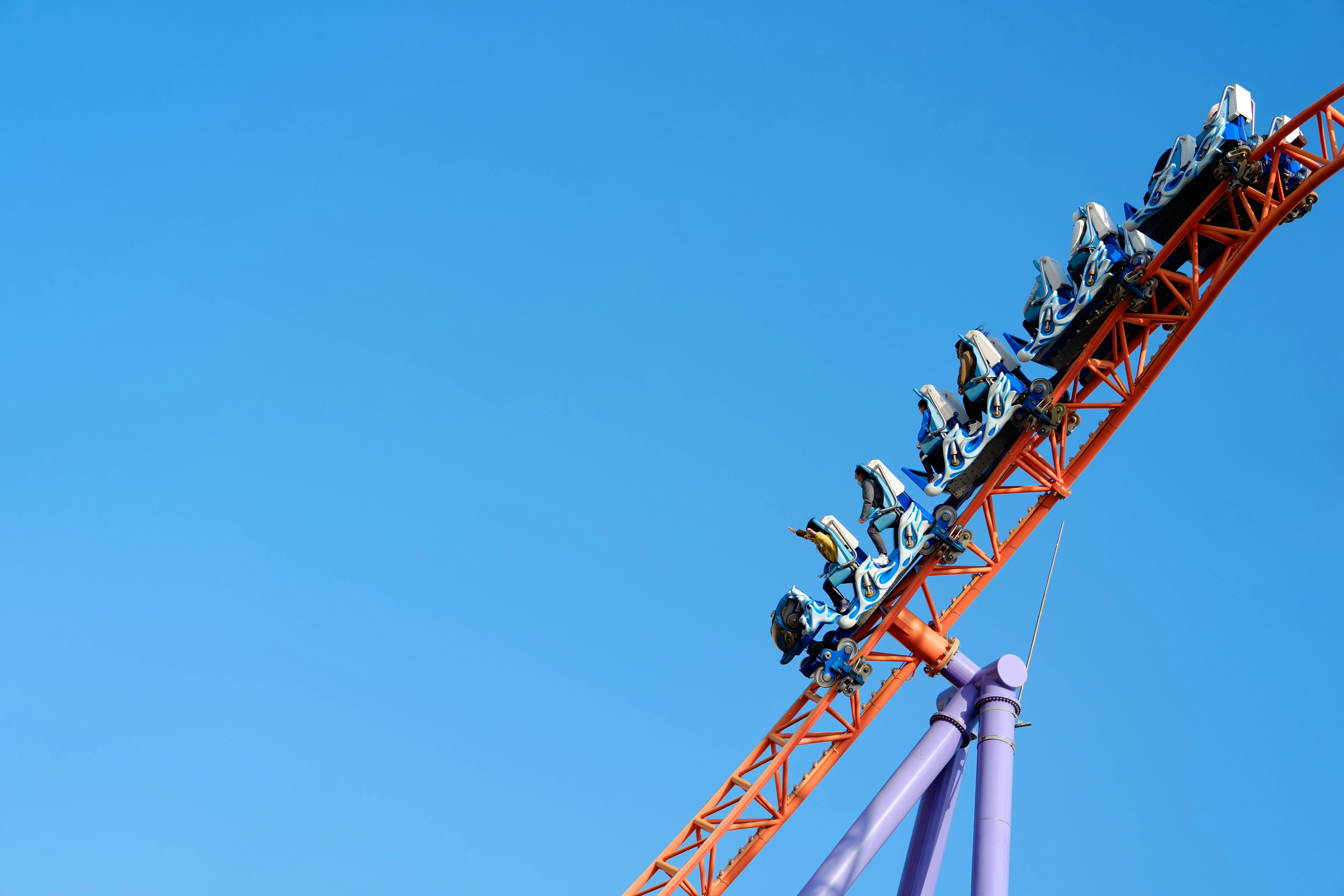 Exciting roller coaster ride with clear blue sky at a theme park