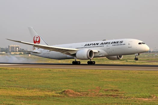 A Japan Airlines Boeing 787 Dreamliner smoothly lands on a runway, showcasing aviation excellence.