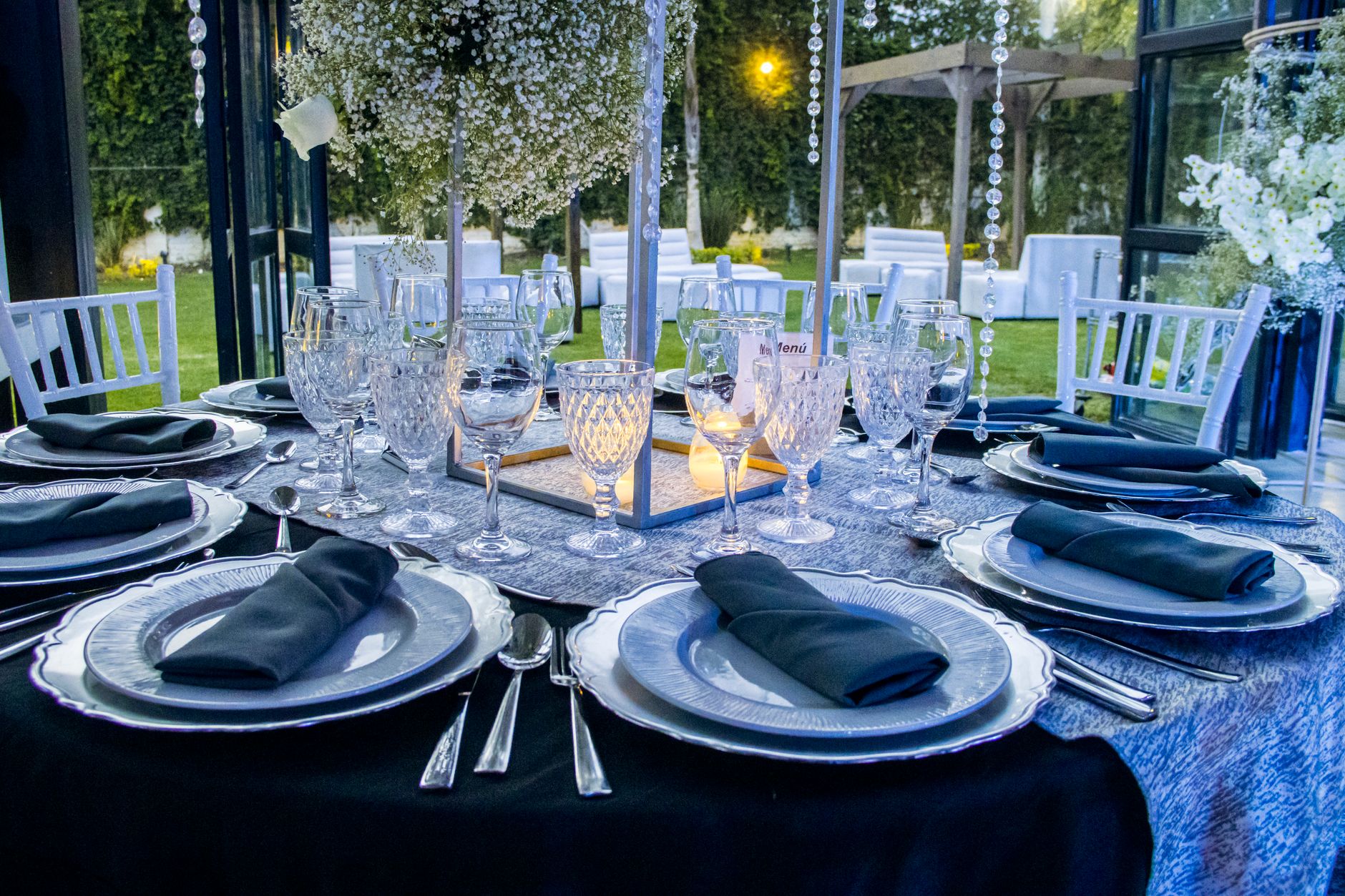 Elegant outdoor dinner party on a luxury estate terrace in the Hollywood Hills at sunset