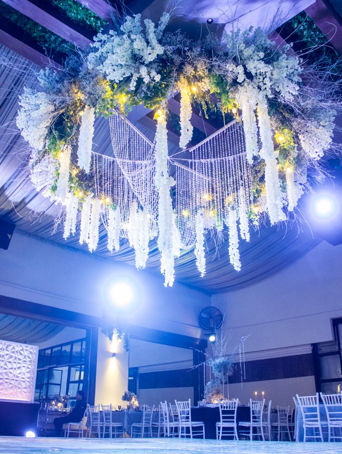 Illuminated floral ceiling installation at a venue