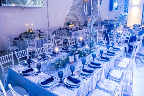Free Luxurious reception hall with elegant table settings and floral decorations, perfect for events. Stock Photo