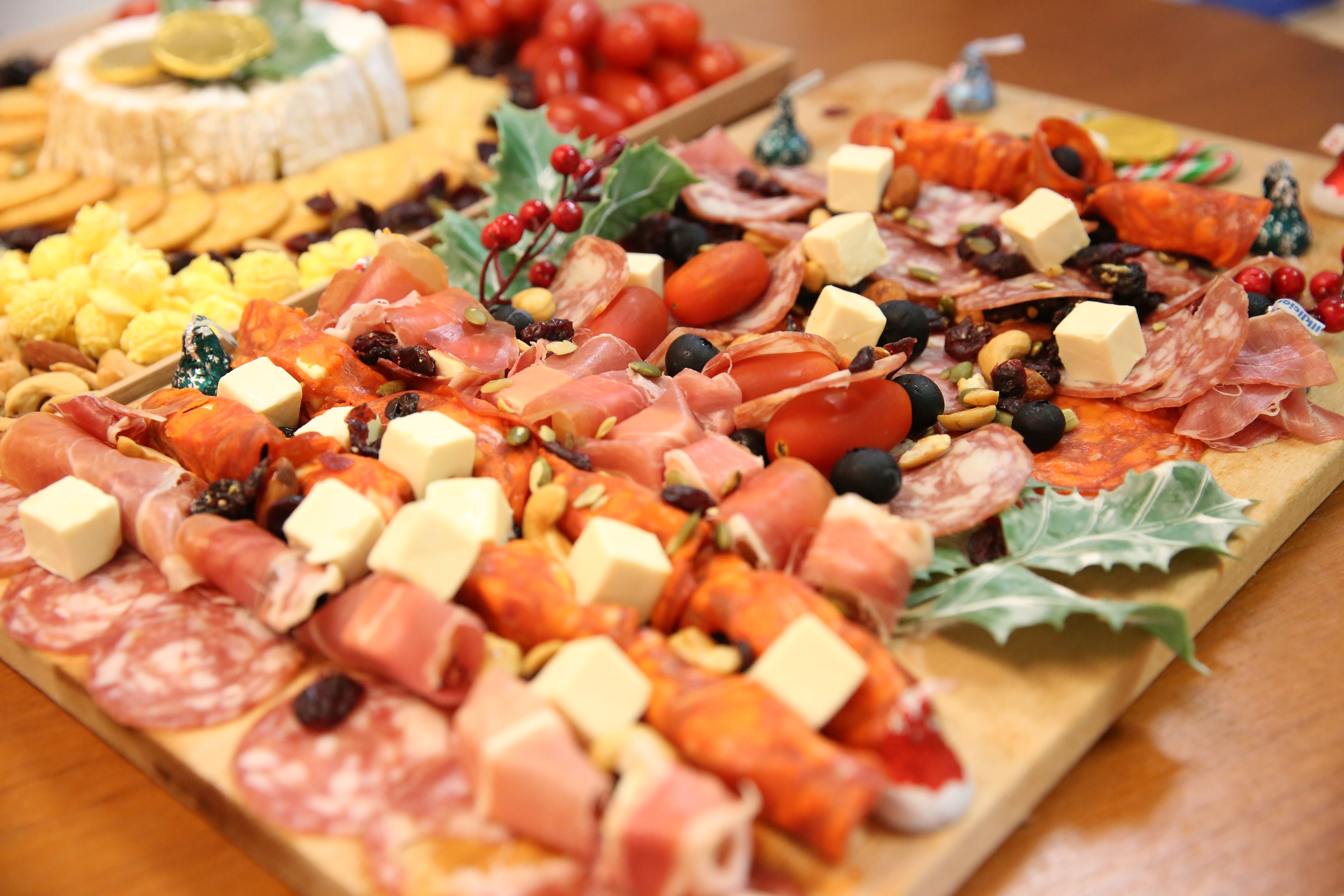Close view of a grazing board with meats, cheese and fruit