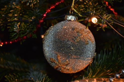 Shiny Silver Bauble on Christmas Tree