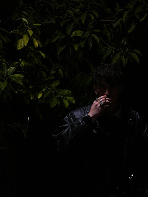 Handsome Man Smoking Cigarette in Dark