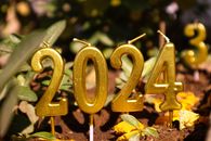 Golden 2024 candles in outdoor setting, perfect for New Year festivities.