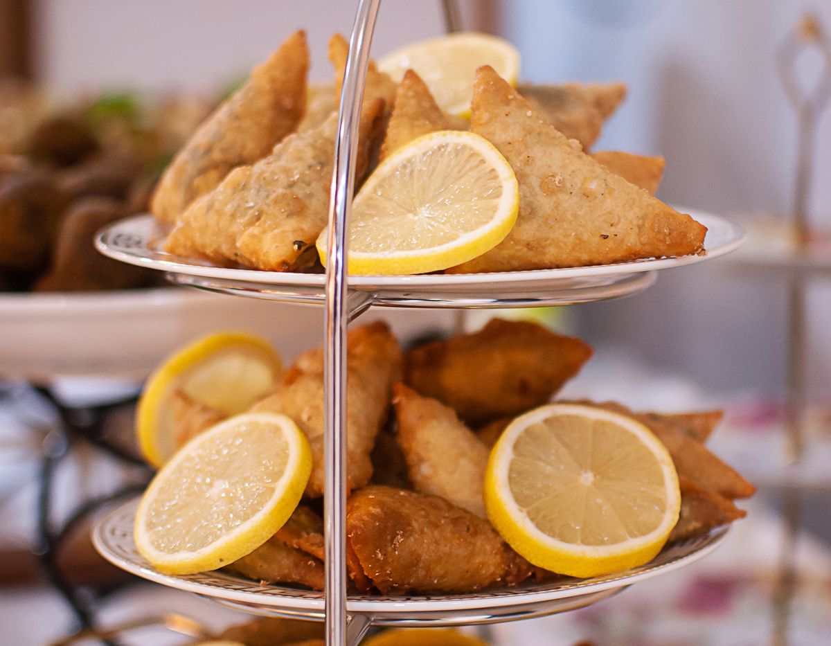 Tiered tray of samosas with lemon slices