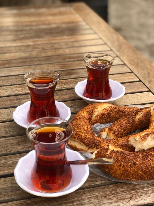 Free A serene outdoor setting with Turkish tea and simit bagel on a wooden table. Stock Photo