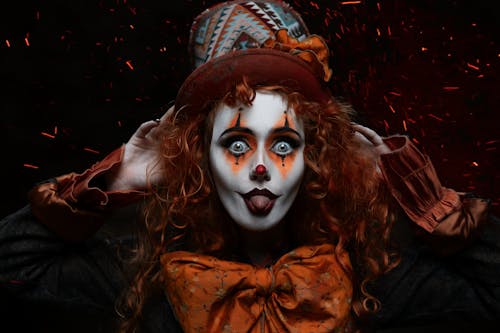 Portrait of a Clown in a Top Hat with Her Tongue Sticking Out