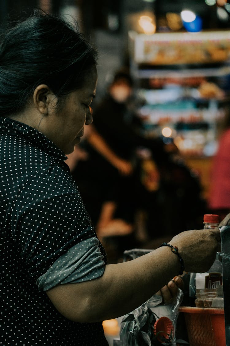 Woman In Polka Dot Shirt Shopping In Grocery Store