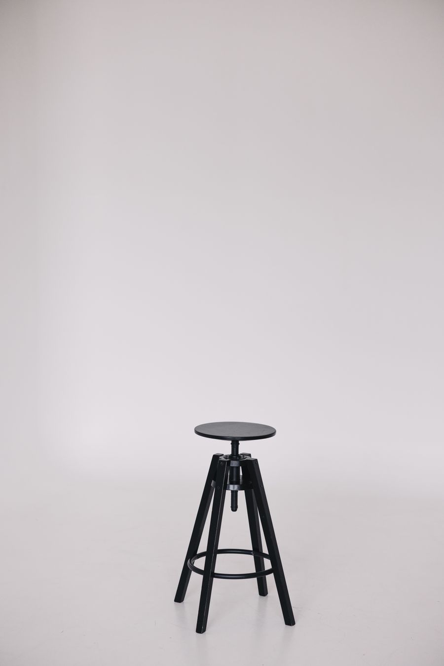 Black stool on a white backdrop — photo by Lisett Kruusimäe on Pexels