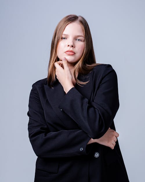 Woman in a Black Blazer Posing in the Studio