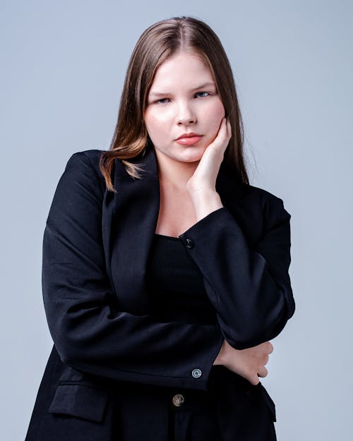 Woman in Black Blazer Posing on White Background