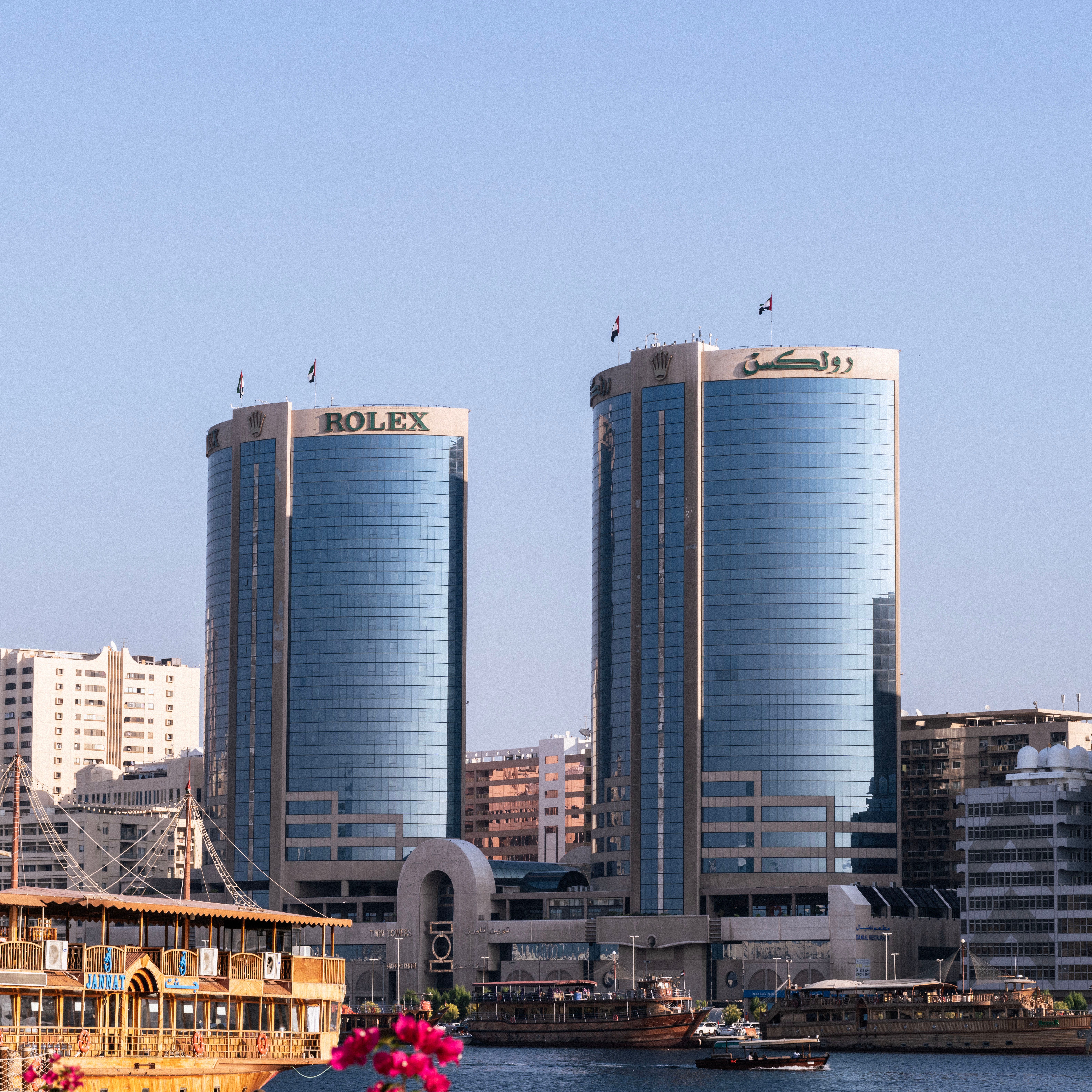 Stunning view of the Rolex Towers in Dubai against a clear blue sky, showcasing urban architecture.