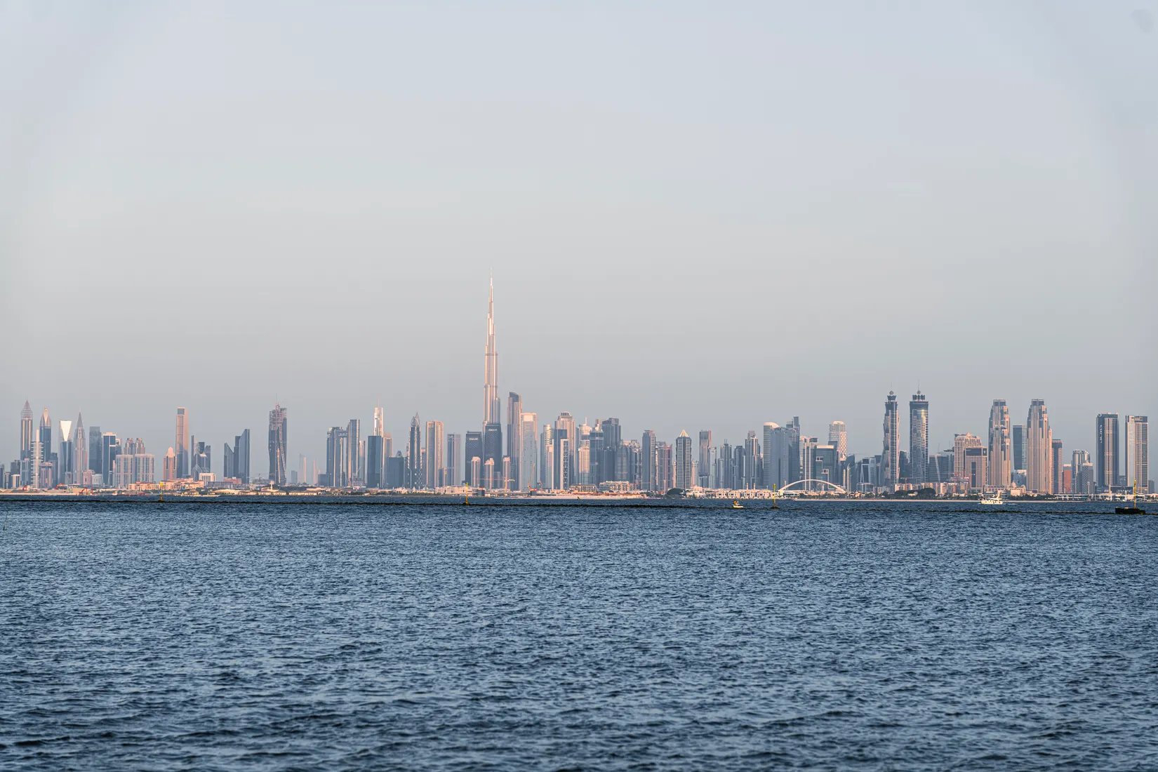 Dubai skyline over the creek at golden hour with the Burj Khalifa in the distance