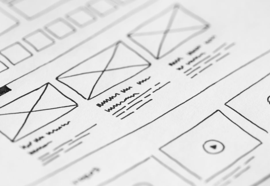 Detailed close-up of a hand-drawn wireframe design on paper for a UX project.
