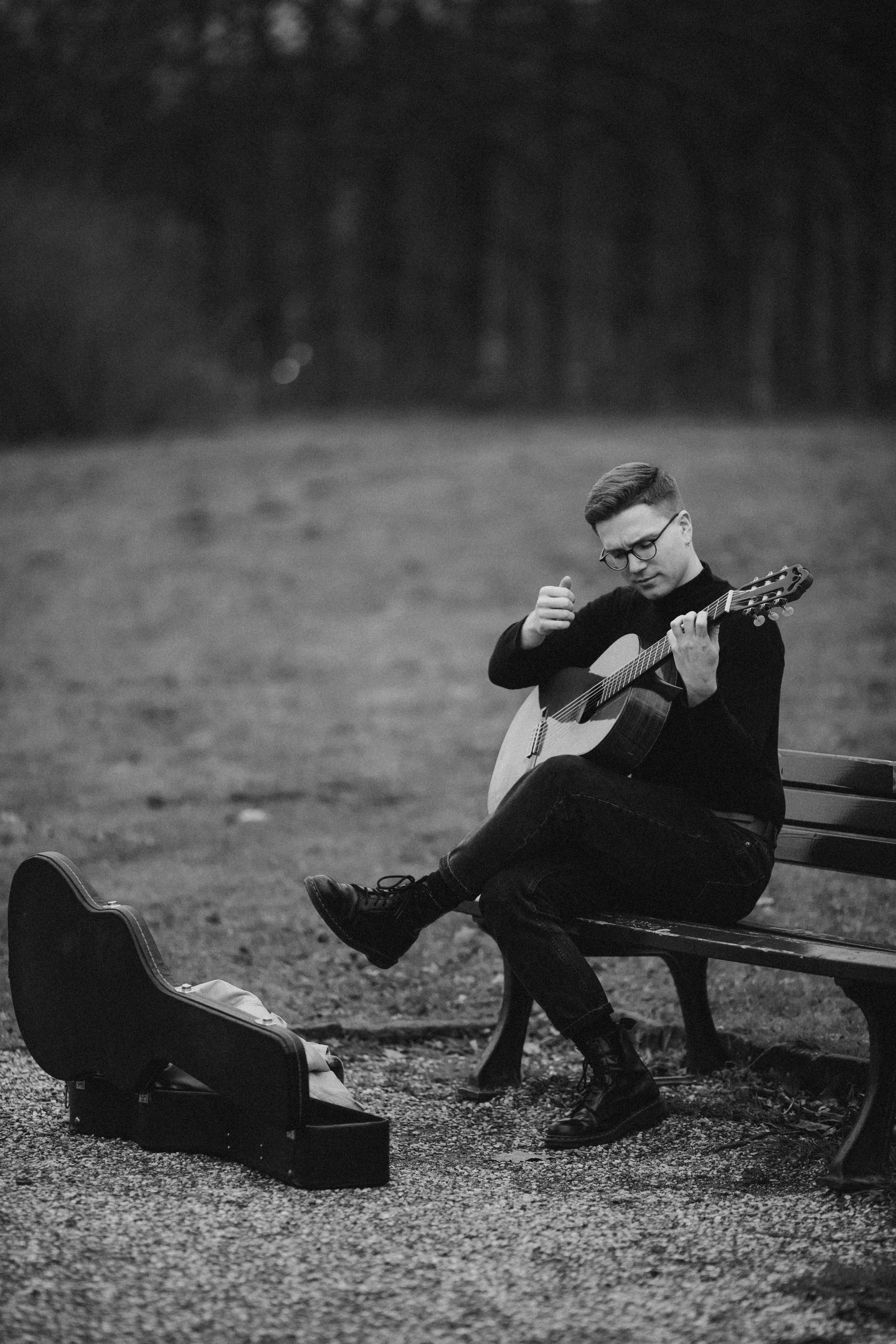 Man Sitting and Playing Guitar on Bench · Free Stock Photo
