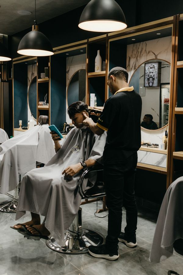 Barber working on a client in a row of barber chairs