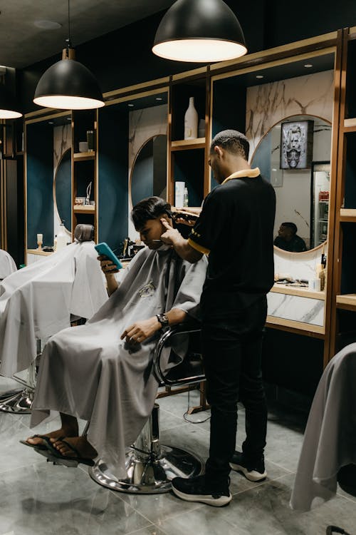 Free A man getting his hair cut in a barber shop Stock Photo