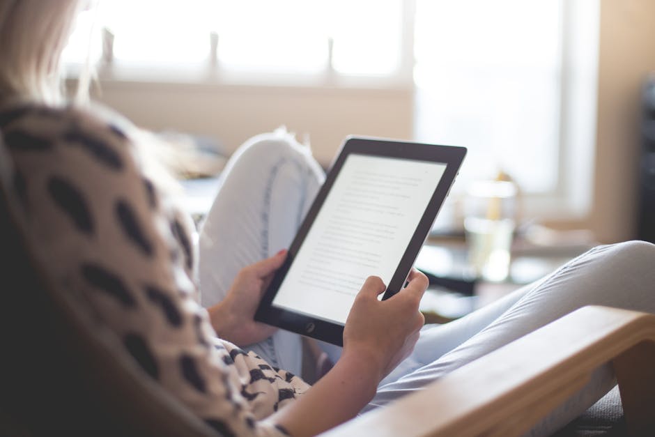 Woman Sitting on Chair Using Black Ipad